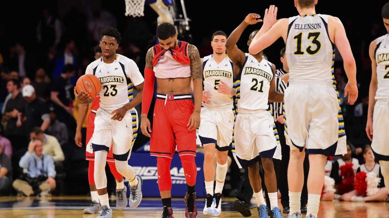 Marquette celebrates as St. John's forward Ron Mvouika (24) is dejected after his team is defeated during the Big East Tournament at Madison Square Garden in New York, New York on Wednesday, Mar 9, 2016.