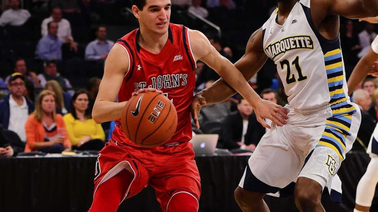 St. John's guard Federico Mussini (4) drives the baseline defended by Marquette guard Traci Carter (21) during the Big East Tournament at Madison Square Garden in New York, New York on Wednesday, Mar 9, 2016. Big East Basketball Tournament between #10 St. John's and #7 Marquette.