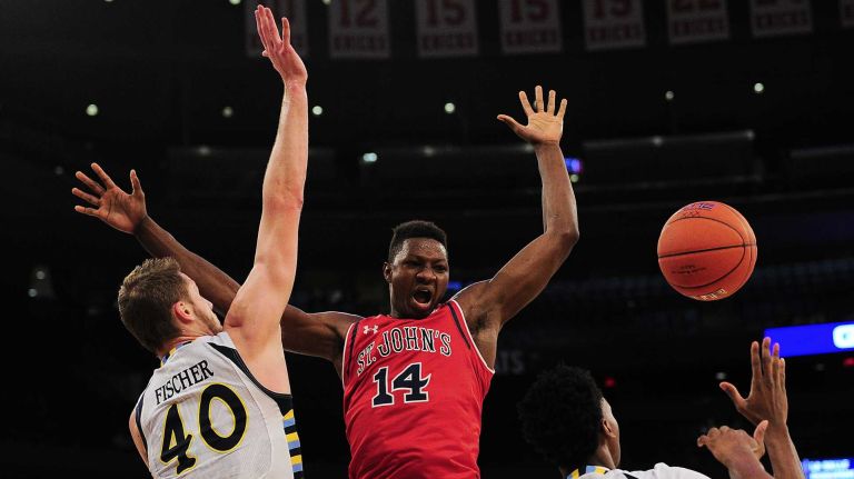 St. John's forward Kassoum Yakwe (14) battles for the rebound with Marquette center Luke Fischer (40) and guard Jajuan Johnson (23) during the Big East Tournament at Madison Square Garden in New York, New York on Wednesday, Mar 9, 2016. 