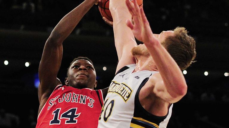 St. John's forward Kassoum Yakwe (14) is defended by Marquette center Luke Fischer (40) during the Big East Tournament at Madison Square Garden in New York, New York on Wednesday, Mar 9, 2016. Big East Basketball Tournament between #10 St. John's and #7 Marquette.