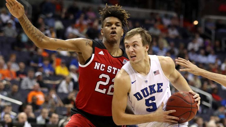 Luke Kennard #5 of the Duke Blue Devils dribbles in front of Shaun Kirk #22 of the North Carolina State Wolfpack during the first half in the second round of the 2016 ACC Basketball Tournament at Verizon Center on March 9, 2016 in Washington, DC.
