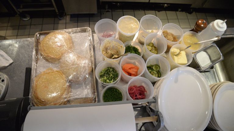 Blini, sour cream, scallions, chives, pickled fennel and onions, two types of pickles, smoked salmon, whitefish salad, smoked and peppered mackerel, hard-boiled eggs, smoked sable, bacon, red onions, dill and ikura salmon caviar. 