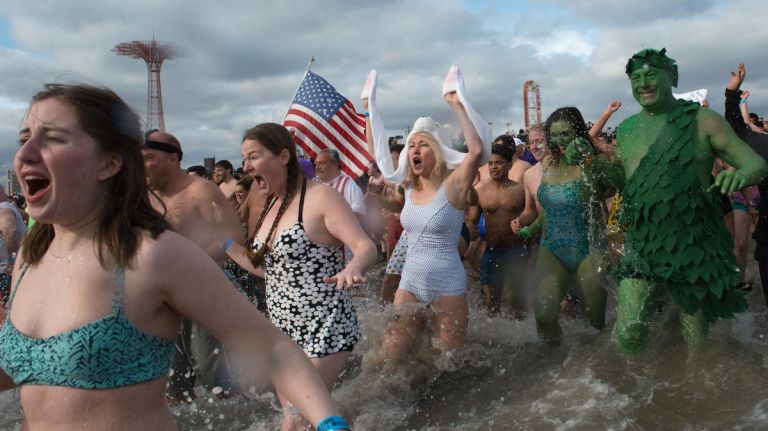 People in bathing suits run into the ocean during the annual Coney Island Polar Bear Club New Year's Day swim on Jan. 1, 2016.