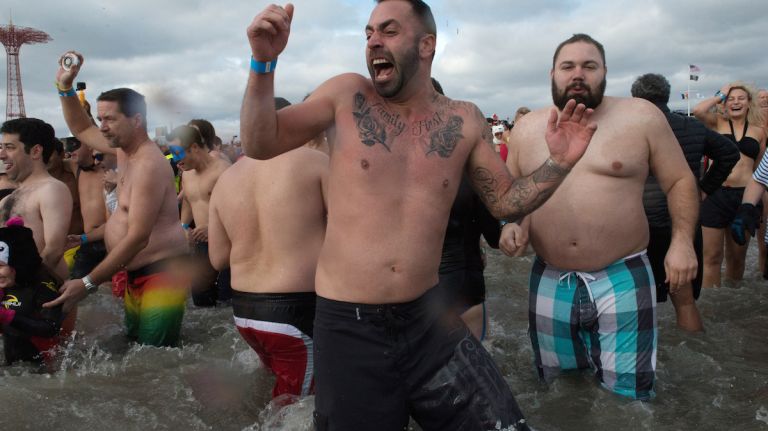 People in bathing suits run into the ocean during the annual Coney Island Polar Bear Club New Year's Day swim on Jan. 1, 2016.