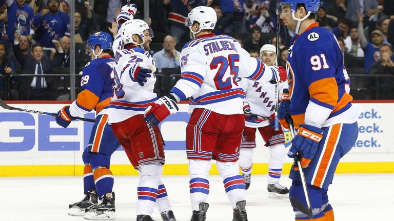 Viktor Stalberg #25 of the New York Rangers celebrates his second period goal against the New York Islanders with teamate Dominic Moore #28 at Barclays Center on Wednesday, Dec. 30, 2015 in Brooklyn, New York.