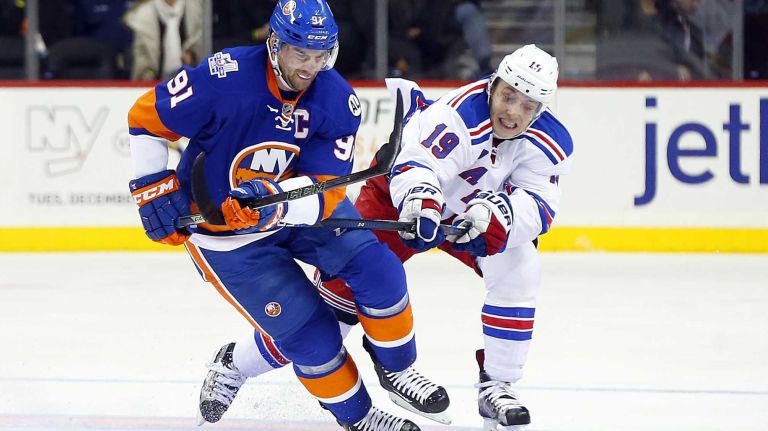 John Tavares #91 of the New York Islanders skates up ice with the puck in the first period against Jesper Fast #19 of the New York Rangers at Barclays Center on Wednesday, Dec. 30, 2015 in Brooklyn, New York.