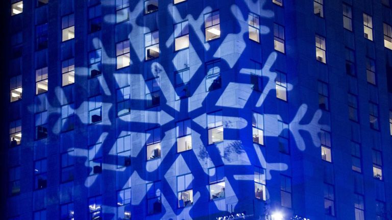 A giant snowflake casts a shadow on a building at the Rockefeller Center Christmas tree lighting ceremony in Manhattan on Dec. 2, 2015.