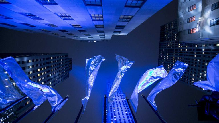Flags fly at the Rockefeller Center Christmas tree lighting ceremony in Manhattan on Dec. 2, 2015.