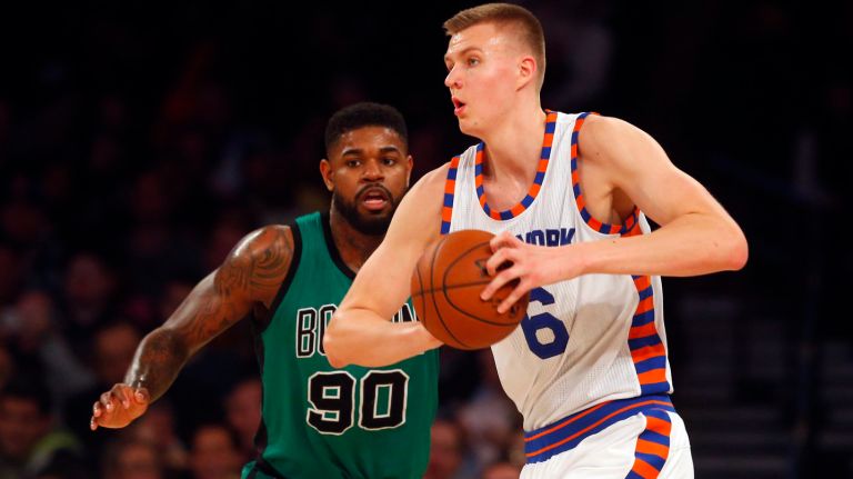 Kristaps Porzingis #6 of the New York Knicks controls the ball in the first half against Amir Johnson #90 of the Boston Celtics at Madison Square Garden on Tuesday, Jan. 12, 2016 in New York City.