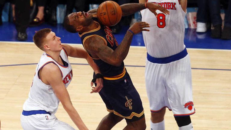 LeBron James #23 of the Cleveland Cavaliers is fouled in the fourth quarter by Kristaps Porzingis #6 of the New York Knicks at Madison Square Garden on Friday, Nov. 13, 2015 in New York City.