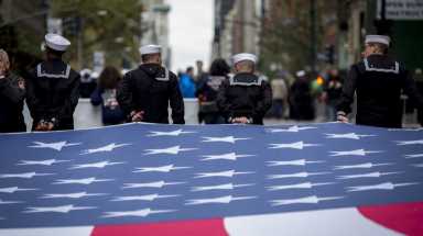 Sailors carry an American flag as they march in the 96th annual New York City Veterans Day Parade in lower Manhattan on Wednesday, Nov. 11, 2015.