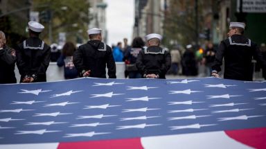 Sailors carry an American flag as they march in the 96th annual New York City Veterans Day Parade in lower Manhattan on Wednesday, Nov. 11, 2015.