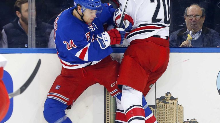 Oscar Lindberg of the New York Rangers checks Riley Nash of the Carolina Hurricanes in the first period at Madison Square Garden on Tuesday, Nov. 10, 2015.