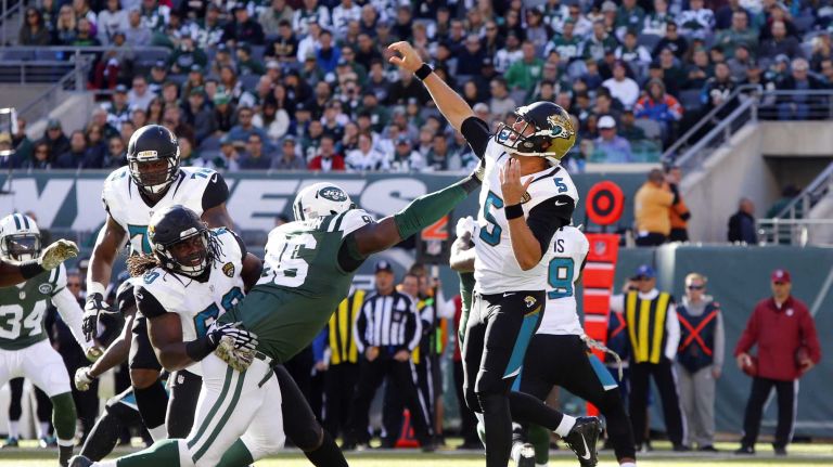 Blake Bortles #5 of the Jacksonville Jaguars throws a pass in the first half under pressure from Muhammad Wilkerson #96 of the New York Jets at MetLife Stadium on Sunday, Nov. 8, 2015 in East Rutherford, N.J.