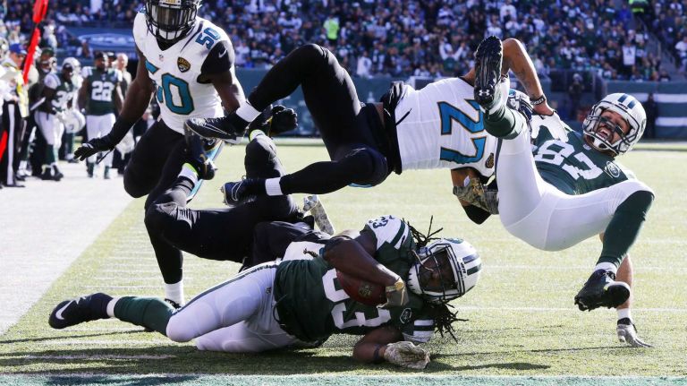 Chris Ivory #33 of the New York Jets is down just short of the goal line in the first quarter as teammate Eric Decker #87 is taken out by Dwayne Gratz #27 of the Jacksonville Jaguars at MetLife Stadium on Sunday, Nov. 8, 2015 in East Rutherford, N.J.