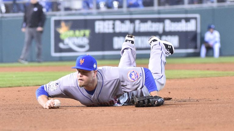 World Series Game 2: Mets vs. Royals 46 New York Mets first baseman Lucas Duda (21) attempts to handle a ground ball by Kansas City Royals second baseman Ben Zobrist (18) in fourth inning during Game 2 of the World Series against the Kansas City Royals at Kauffman Stadium on Wednesday, Oct. 28, 2015.