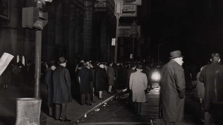 A searchlight illuminates Seventh Avenue in front of Penn Station in Manhattan as commuters look for rides home during the blackout on Nov. 9, 1965.