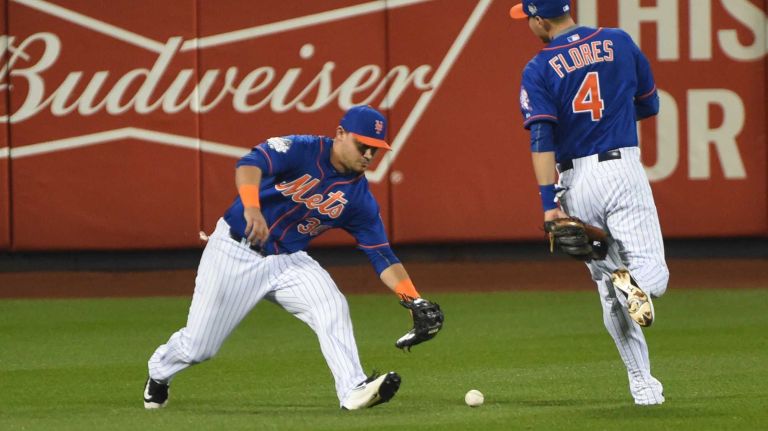 World Series Game 5: Mets vs. Royals 162 New York Mets leftfielder Michael Conforto (30) and New York Mets shortstop Wilmer Flores (4) go after the hit by Kansas City Royals centerfielder Lorenzo Cain (6) in the first inning during Game 5 of the World Series at Citi Field on Sunday, Nov. 1, 2015.