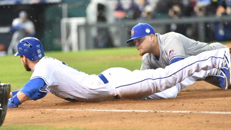 World Series Game 2: Mets vs. Royals 47 New York Mets first baseman Lucas Duda (21) dives back to the bag to try and get Kansas City Royals second baseman Ben Zobrist (18) out at 1st base after he caught the ball in fourth inning during Game 2 of the World Series against the Kansas City Royals at Kauffman Stadium on Wednesday, Oct. 28, 2015.