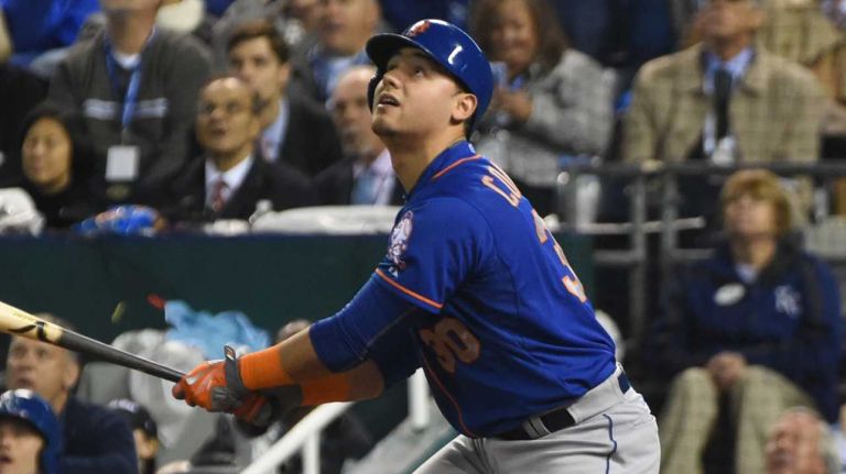 World Series Game 1: Mets vs. Royals 101 New York Mets leftfielder Michael Conforto (30) hits an RBI sacrifice fly as New York Mets cente fielder Yoenis Cespedes (52) scores in the sixth inning during Game 1 of the World Series against the Kansas City Royals at Kauffman Stadium on Tuesday, Oct. 27, 2015.