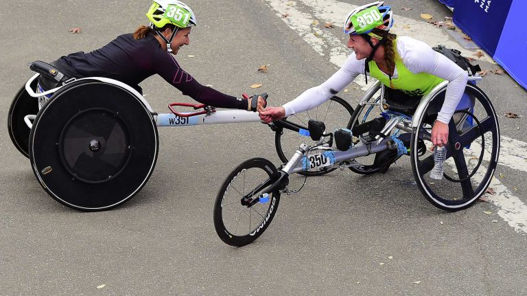 Tatyana McFadden of the United States, right, congratulates Manuela Schar of Switzerland after they finished first and second in the women's Pushrim New York City Marathon in Manhattan on Sunday, Nov. 1, 2015.