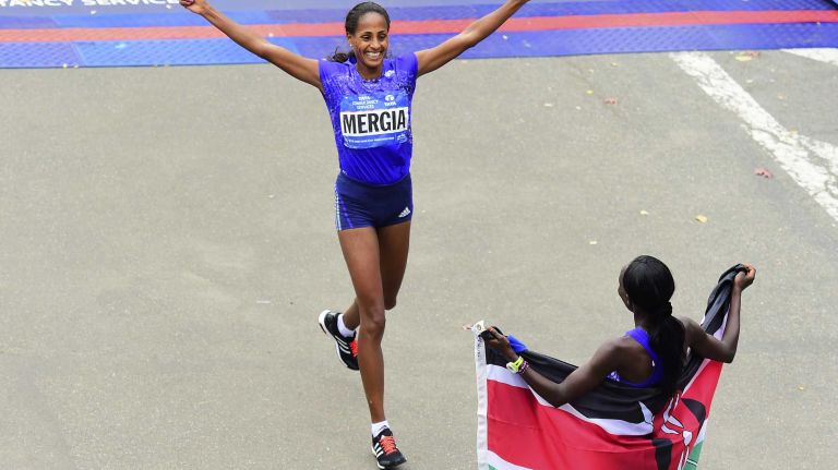 Aselefech Mergia of Ethiopia finishes in second place and is greeted by winner Mary Keitany of Kenya in the Women's New York City Marathon in Manhattan on Sunday, Nov. 1, 2015.