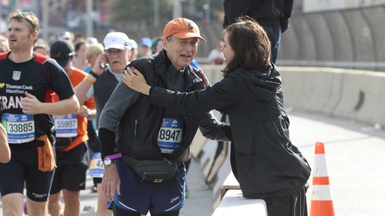 Helen Schreiner greets her boss, Ted Rogers, at the halfway point of the New York City Marathon in Brooklyn on Nov. 1, 2015.