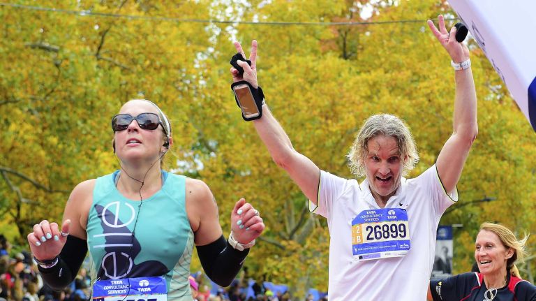 Runners cheer at the finish line of the New York City Marathon in Manhattan on Sunday, Nov. 1, 2015.
