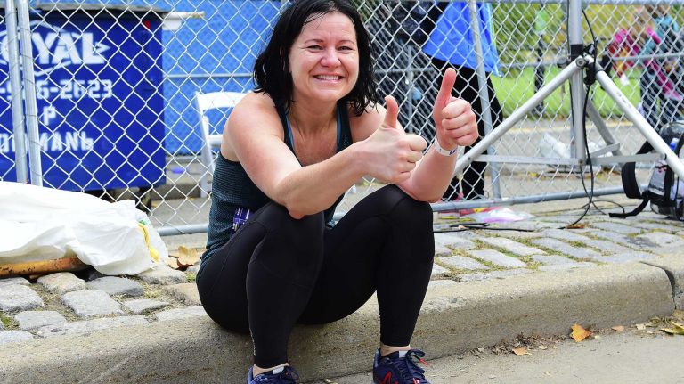 New Yorker Catrin Svensson gives a thumbs-up after finishing the New York City Marathon in Manhattan on Sunday, Nov. 1, 2015.