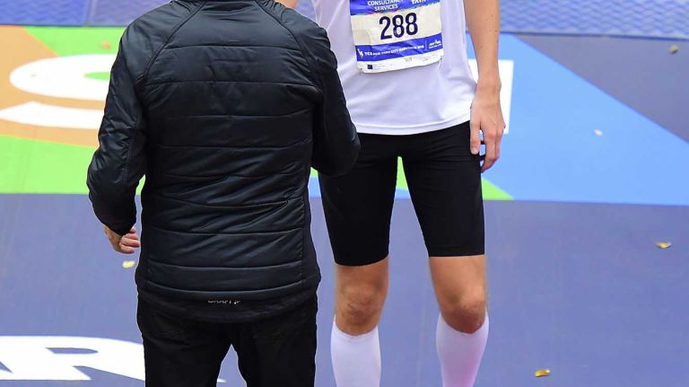 Race director Peter Ciaccia greets Conor Shelley of Rockville Centre at the finish line of the New York City Marathon in Manhattan on Sunday, Nov. 1, 2015.