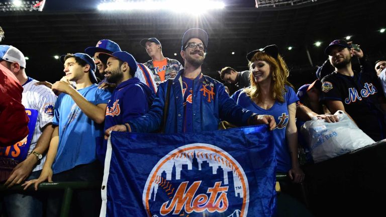 New York Mets fans celebrate their victory in Game 4 of the NLCS against the Chicago Cubs at Wrigley Field on Wednesday, Oct. 21, 2015.