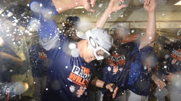 New York Mets centerfielder Juan Lagares (12) and teammates celebrate after beating the Chicago Cubs in the NLCS at Wrigley Field on Wednesday, Oct. 21, 2015.