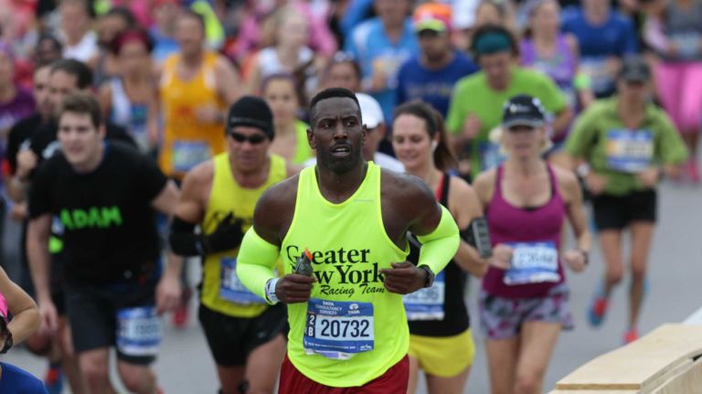 New York City Marathon participants run along the race route in Brooklyn on Nov. 1, 2015.