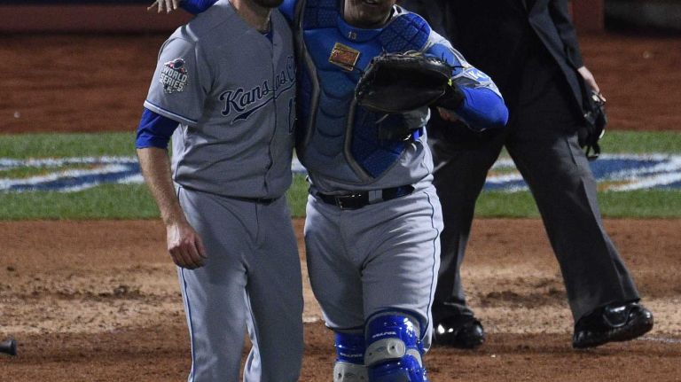 Kansas City Royals relief pitcher Wade Davis and catcher Salvador Perez celebrate their 5-3 win against the New York Mets in Game 4 of the World Series at Citi Field on Saturday, Oct. 31, 2015.