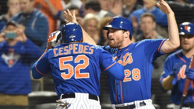 New York Mets center fielder Yoenis Cespedes (52) smacks a three-run homer in the bottom of the 4th inning and is greeted by teammate New York Mets second baseman Daniel Murphy (28) as the Mets vs. Dodgers at Citi Field in Queens during Game 3 of the NLDS on Monday, Oct. 12, 2015.