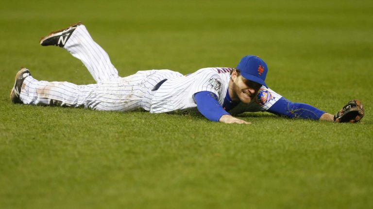 New York Mets second baseman Daniel Murphy (28) cannot get to the ball hit by Kansas City Royals third baseman Mike Moustakas (8) in eighth inning as Kansas City Royals takes the lead during Game 4 of the World Series against the Kansas City Royals at Citi Field on Saturday, Oct. 31, 2015.