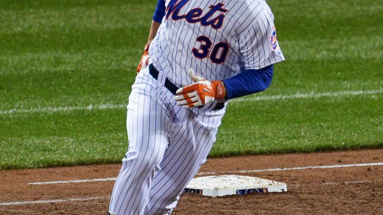 New York Mets left fielder Michael Conforto reacts after his second solo home run during Game 4 of the World Series against the Kansas City Royals at Citi Field on Saturday, Oct. 31, 2015.
