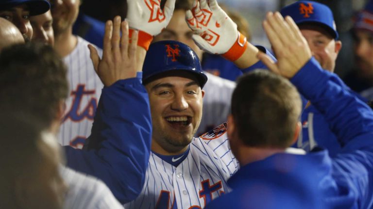 New York Mets left fielder Michael Conforto (30) is all smiles in dugout after his fifth inning homerun during Game 4 of the World Series against the Kansas City Royals at Citi Field on Saturday, Oct. 31, 2015.
