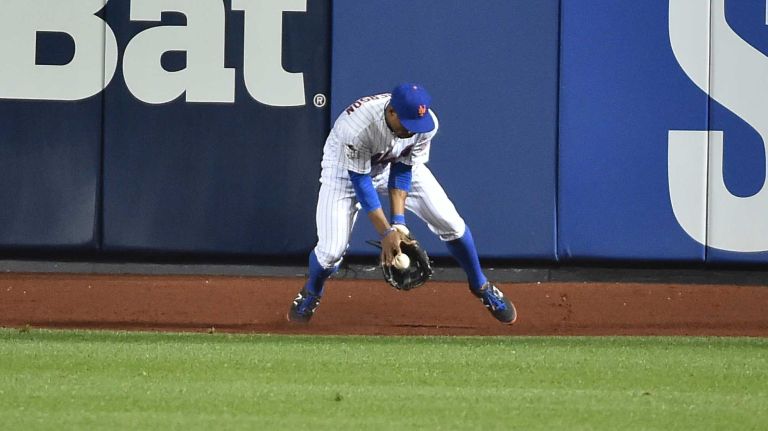 New York Mets right fielder Curtis Granderson (3) grabs the ball hit by Kansas City Royals left fielder Alex Gordon (4) in fifth inning during Game 4 of the World Series against the Kansas City Royals at Citi Field on Saturday, Oct. 31, 2015.