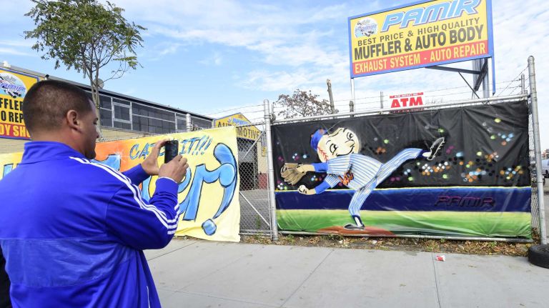 A fan takes a photo of the Mr. Met painting on 126th Street in Flushing before Game 4 of the World Series against the Kansas City Royals at Citi Field on Saturday, Oct. 31, 2015.