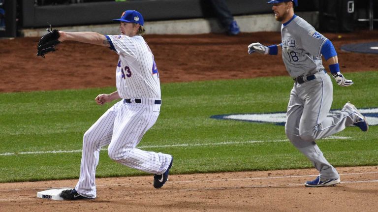New York Mets relief pitcher Addison Reed steps on first to force out second baseman Ben Zobrist during Game 3 of the World Series at Citi Field on Friday, Oct. 30, 2015.