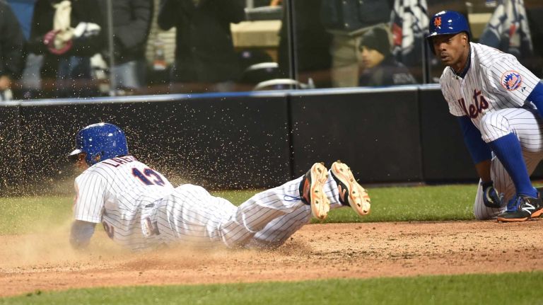 New York Mets centerfielder Juan Lagares scores in the sixth inning during Game 3 of the World Series against the Kansas City Royals at Citi Field on Friday, Oct. 30, 2015.