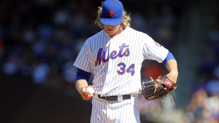 Subway Series: Yankees vs. Mets 70 Noah Syndergaard #34 of the New York Mets looks at the ball on the mound in the first inning against the New York Yankees at Citi Field on Saturday, Sept. 19, 2015 .