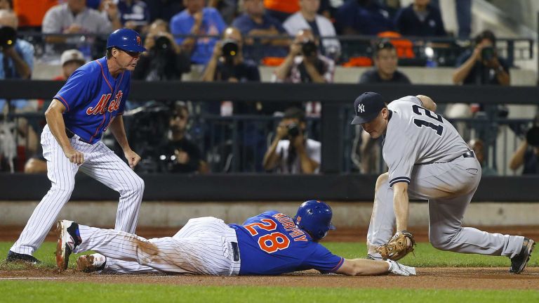 Subway Series: Yankees vs. Mets 73 Daniel Murphy of the New York Mets is safe at third base with an eighth-inning triple ahead of the tag from Chase Headley of the New York Yankees at Citi Field on Friday, Sept. 18, 2015.