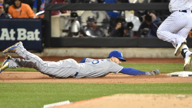 New York Mets left fielder Michael Conforto hits first base ahead of Kansas City Royals first baseman Eric Hosmer for the single in the fourth inning during Game 3 of the World Series against the Kansas City Royals at Citi Field on Friday, Oct. 30, 2015.
