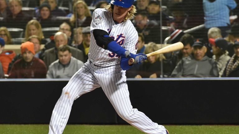 New York Mets starting pitcher Noah Syndergaard smacks a single in the third inning during Game 3 of the World Series against the Kansas City Royals at Citi Field on Friday, Oct. 30, 2015.