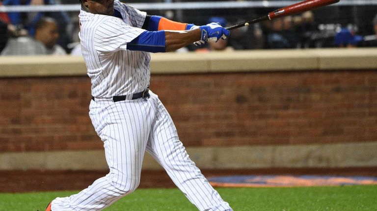 New York Mets second baseman Juan Uribe doubles against the Miami Marlins during the sixth inning of a game at Citi Field on Monday, Sept. 14, 2015.