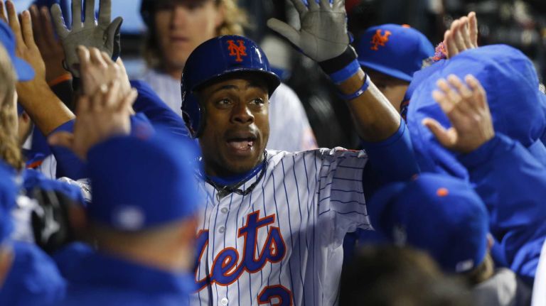 New York Mets right fielder Curtis Granderson celebrates in the dugout during Game 3 of the World Series against the Kansas City Royals at Citi Field on Friday, Oct. 30, 2015.