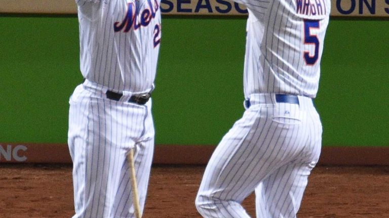 New York Mets second baseman Daniel Murphy congratulates third baseman David Wright after his two-run home run in the first inning during Game 3 of the World Series against the Kansas City Royals at Citi Field on Friday, Oct. 30, 2015.