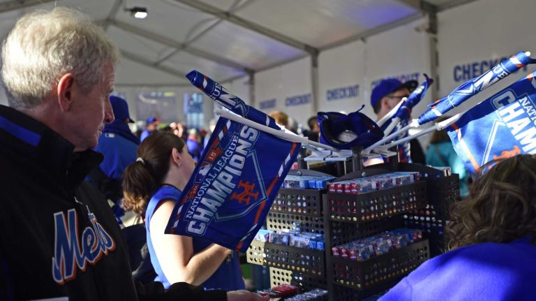 New York Mets fans pack the merchandise tent to grab souvenirs before Game 3 of the World Series against the Kansas City Royals at Citi Field on Friday, Oct. 30, 2015.